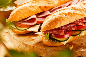 Two fresh tasty baguettes with meat filling