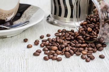 coffee cup and coffee beans on white wooden table