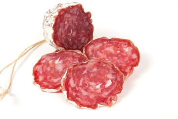pile of red salami, on a white