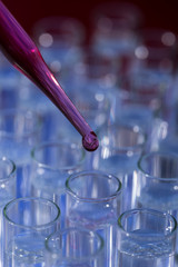 Pipette dropping fluid into test tube