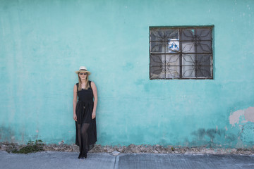 young woman resting against a wall in Tulum, MExico - obrazy, fototapety, plakaty