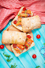 sandwich with smoked salmon on blue wooden table
