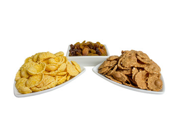 Corn flakes, buckwheat flakes, raisins in a plate. breakfast. Healthy food, diet.
