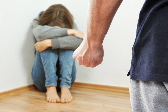 Fist of adult man prepared to hurt the child because of domestic violence