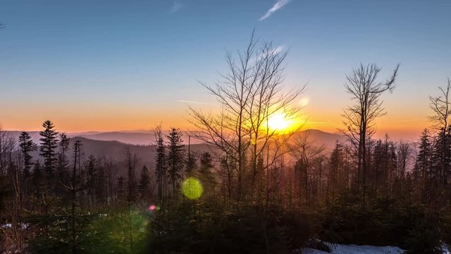 Long distance timelapse of a sunset in the mountains. 4k quality.
