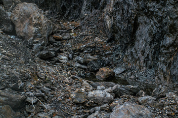 Rocky hillside with small pool of water