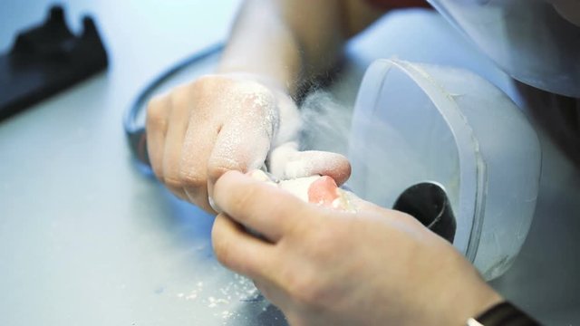 Close up of a dental technician making model of jaw in dental lab 4K
