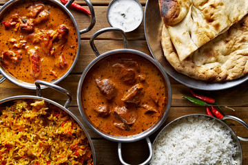 assorted indian curry and rice dishes shot from overhead composition