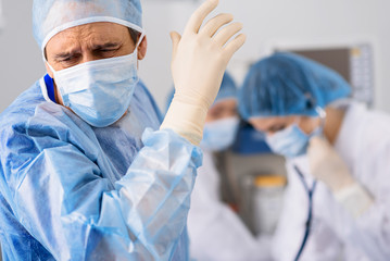 Astonished male doctor in operating room