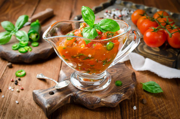 Sauce from tomato, paprika, chili pepper and a branch of basil