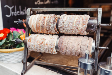 Fototapeta premium Traditional Trdelnik is a sweet bread shaped like a large hollow cupcakes in a shop showcase