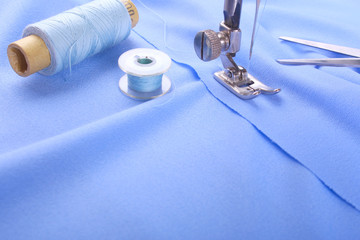 The sewing machine makes the seam on the purple fabric