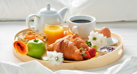 Breakfast tray in bed in hotel room