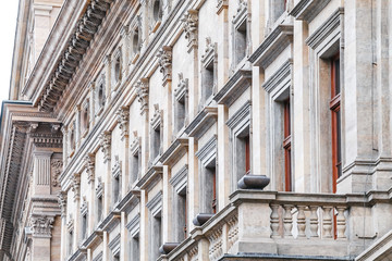 Row of marble columns with dark gaps as classical architectural details with rhythm of Prague National Theater