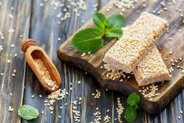 Sesame honey bars and wooden scoop.