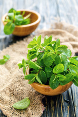 Fresh mint leaves in a wooden bowl.