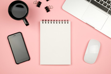 Modern office desk table with laptop, blank notebook page