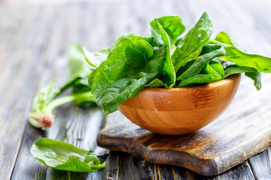 Fresh spinach in a wooden bowl.