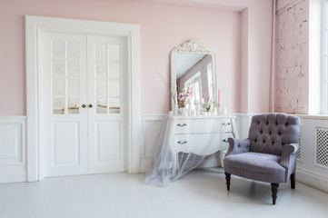 Classical armchair and mirror table at living room interior