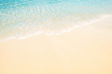Fototapeta na wymiar Soft wave of the sea on the sandy beach for background