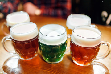 Five authentic crafted mugs of Czech beer in the Prague pub on the table. Different types of beer - light, dark and herbal