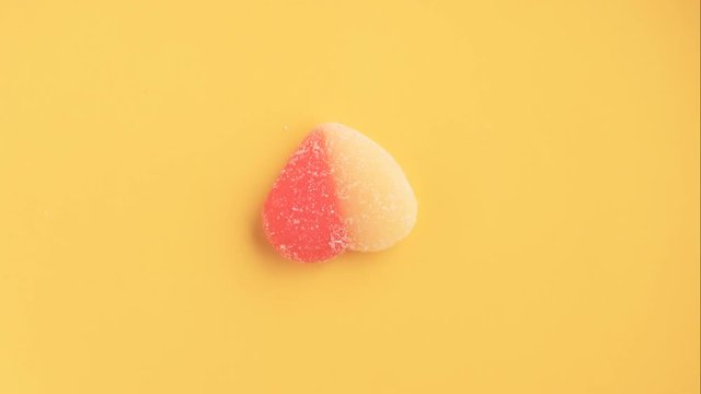Girlish sweets sequence. Colorful youth candies in minimal style yellow background. Sugary food concept.
