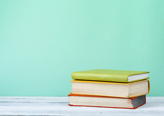 Stack of books on the wooden table. Education background. Back to school.Copy space for text.