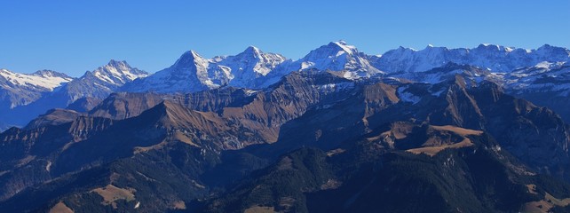 Famous mountains Eiger, Monch and Jungfrau. View from mount Niesen. Autumn day in the Bernese Oberland.