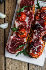 Traditional italian bruschetta with ham and wine