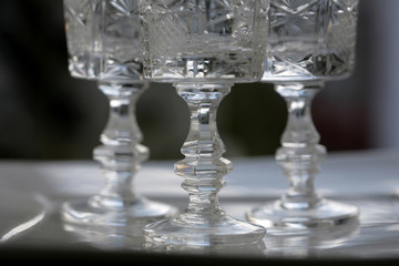 Vintage crystal glasses on white tray.