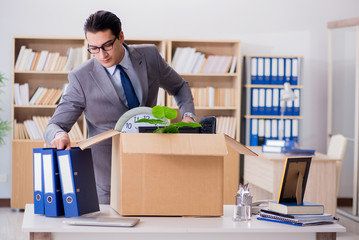 Man moving office with box and his belongings