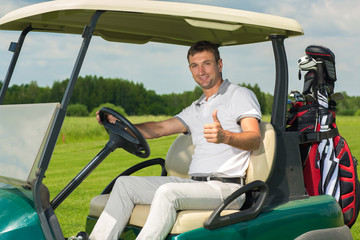 Male golfer in a golf cart