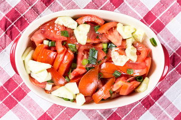 Flat lay sliced tomato and young onions salad on the table