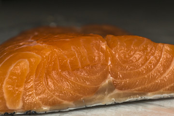 fresh salmon fillet close up on dark background