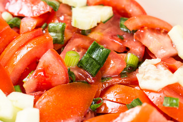 Closeup macro sliced tomato and onions salad on the table