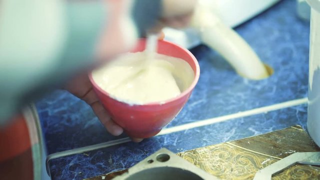 Dental technician mixes the gipsum to making imprint of teeth in 4K