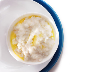 Healthy food - rice porridge with milk  on a white plate