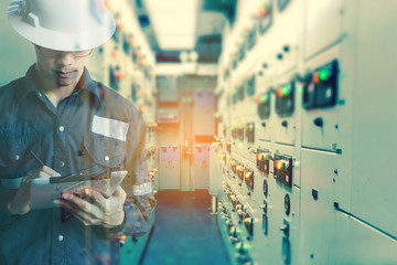 Double exposure of  Engineer or Technician man   working with tablet in switch gear electrical room of oil and gas platform or plant industrial for monitor process, business and industry concept