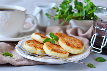 Small pancakes from cottage cheese with blueberry jam for breakfast