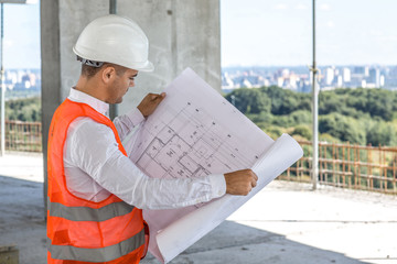 Male engineer checking construction plan