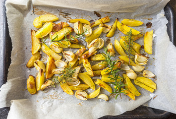 Home made baked potatoes with onion, herbs, pepper and sea salt