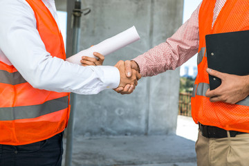 Engineers shaking hands at the construction site