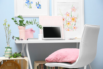 Workplace with laptop on desk in modern room