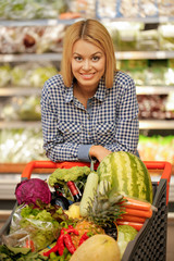 Attractive young female at the supermarket aisle