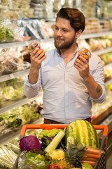 Young bearded man doing groceries at the local store