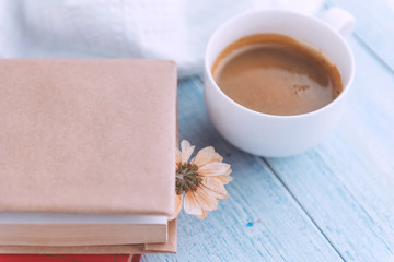 Books on a light table and a cup of coffee on top