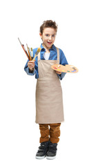 Naklejka premium Cute little artist with brushes and palette on white background