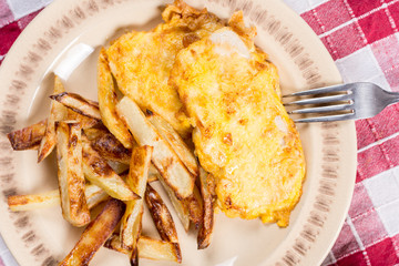Fried chicken white meat with potatoes on the plate