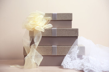 Fototapeta premium Table with gift boxes and veil for wedding day