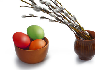 Several osier of willow and colored Easter eggs